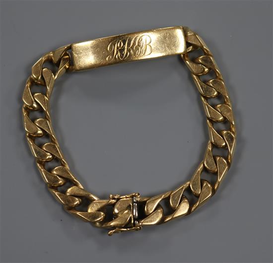 A gentlemens 9ct yellow gold flattened curb-link identity bracelet, with box clasp and safety chain. 53 grams.